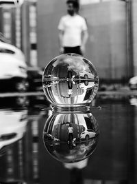 Upside down reflection of man and city and bubble