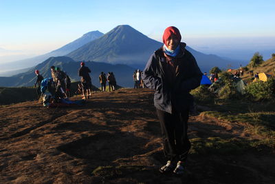 People on mountain road against sky