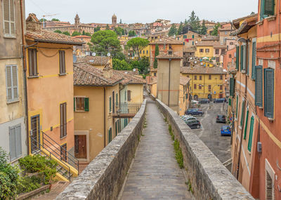 Footpath amidst buildings in city