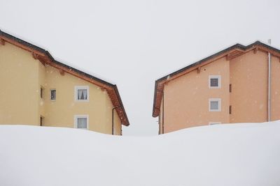 Houses against clear sky during winter