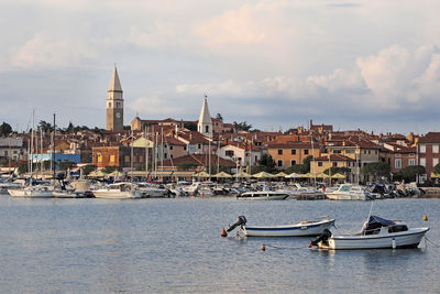 Boats in river with buildings in background