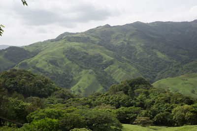 Scenic view of mountains against cloudy sky