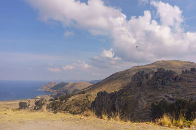 Scenic view of sea and mountains against sky