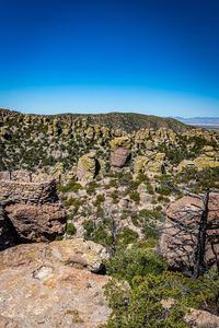 Scenic view of rocky mountains against clear blue sky