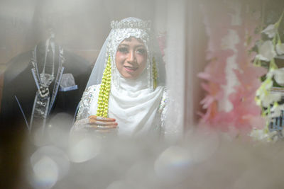 Portrait of happy woman wearing mask