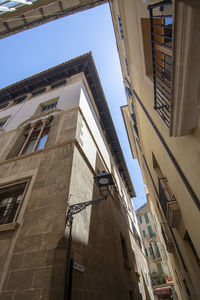 Low angle view of buildings in town against sky