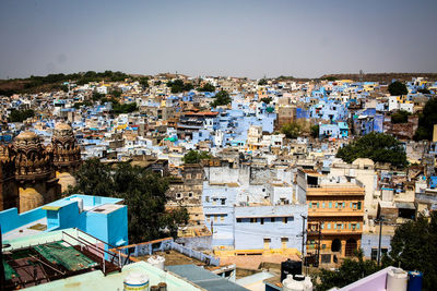 High angle view of buildings in city against clear sky