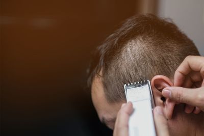 Close-up of man using mobile phone