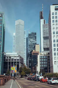 View of city street and buildings against sky