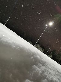 Low angle view of illuminated car against sky at night