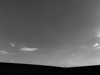 Silhouette landscape against sky