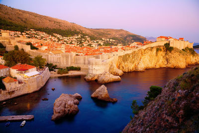 Scenic view of river amidst buildings against clear sky