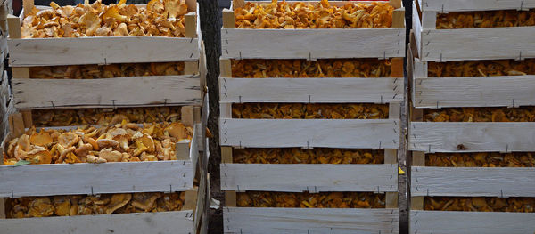 Stacked crates of edible mushrooms for sale at market