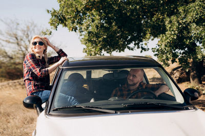 Portrait of woman with sunglasses in car