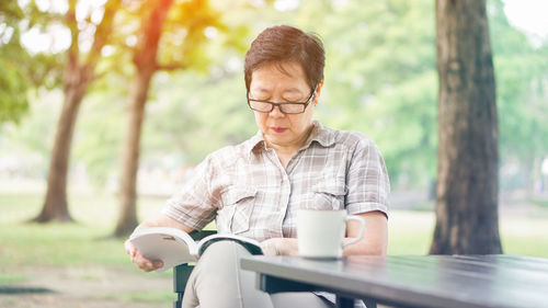 Mid adult man sitting on table