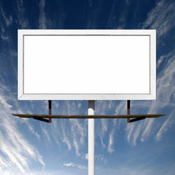 Low angle view of empty sign against sky