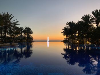 Scenic view of swimming pool against sky during sunset