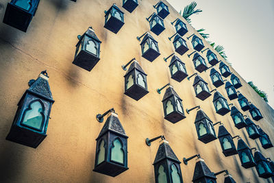 Low angle view of lanterns hanging on wall