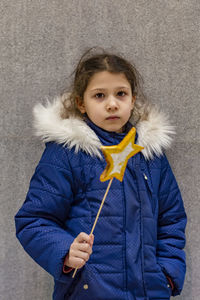 Portrait of cute girl holding snow