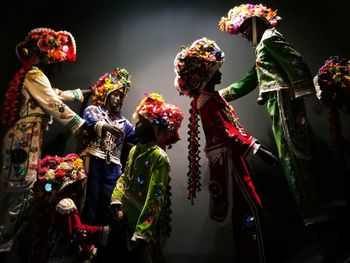 Low angle view of people standing by multi colored flower