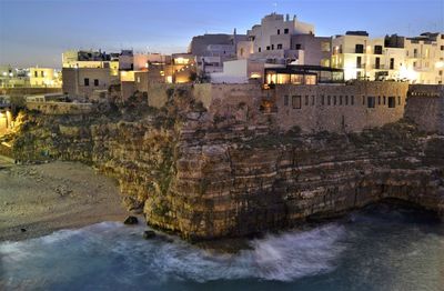 River flowing through buildings in city