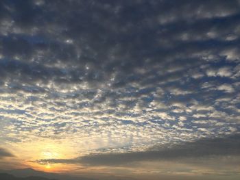 Low angle view of cloudy sky at sunset