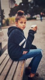 Portrait of boy sitting on bench