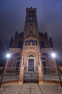 Low angle view of illuminated building against sky at night