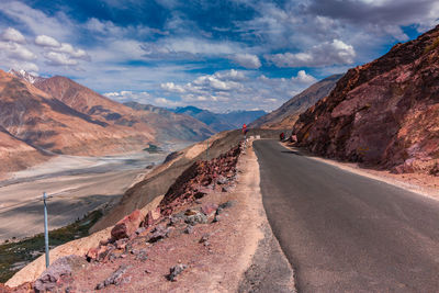 Road amidst mountains against sky