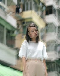 Close-up of girl standing in city