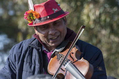 Close-up of man playing violin