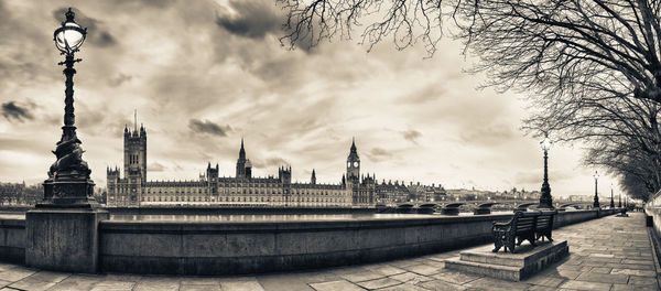 View of buildings in city against cloudy sky