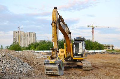 Tractor at construction site against sky