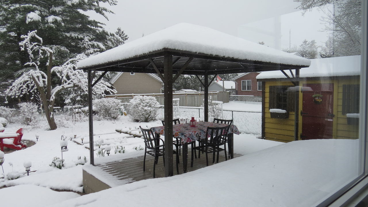 SNOW COVERED CHAIRS AND TABLES BY BUILDING