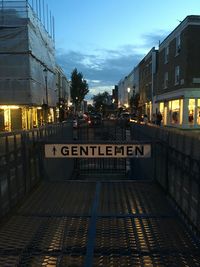Text on illuminated city against sky at night