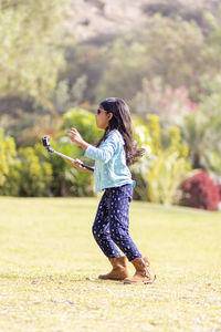 Girl taking selfie while standing on land