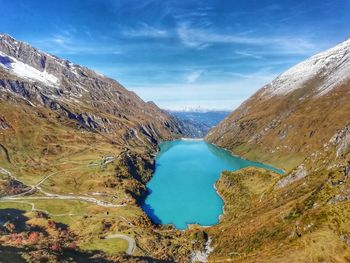 Scenic view of lake by mountains against sky