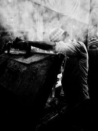 Side view of man working in kitchen