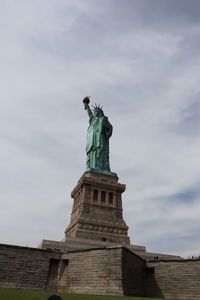 Low angle view of statue against cloudy sky