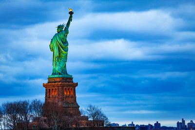 Low angle view of statue against cloudy sky