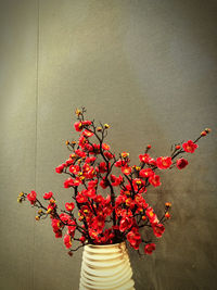 Close-up of red flower vase against wall