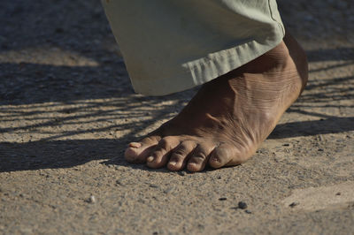 Low section of man walking on street