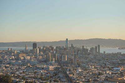 Aerial view of buildings against sky during sunset