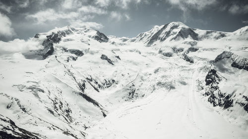 Scenic view of snow covered mountains against sky