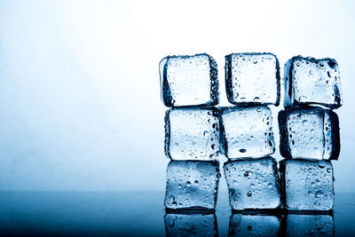 Close-up of ice cubes against blue background