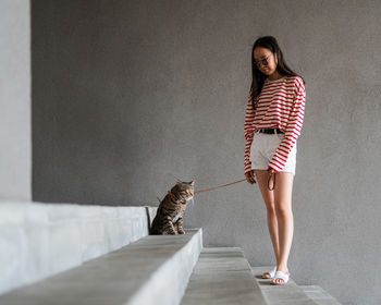 Portrait of young woman walking on floor