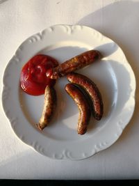 Directly above shot of sausages in plate on table