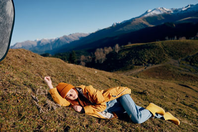 Woman sitting on mountain