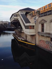 Boats in river with buildings in background