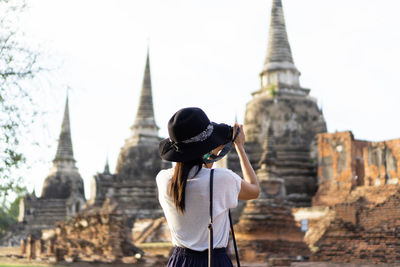 Rear view of man looking at temple